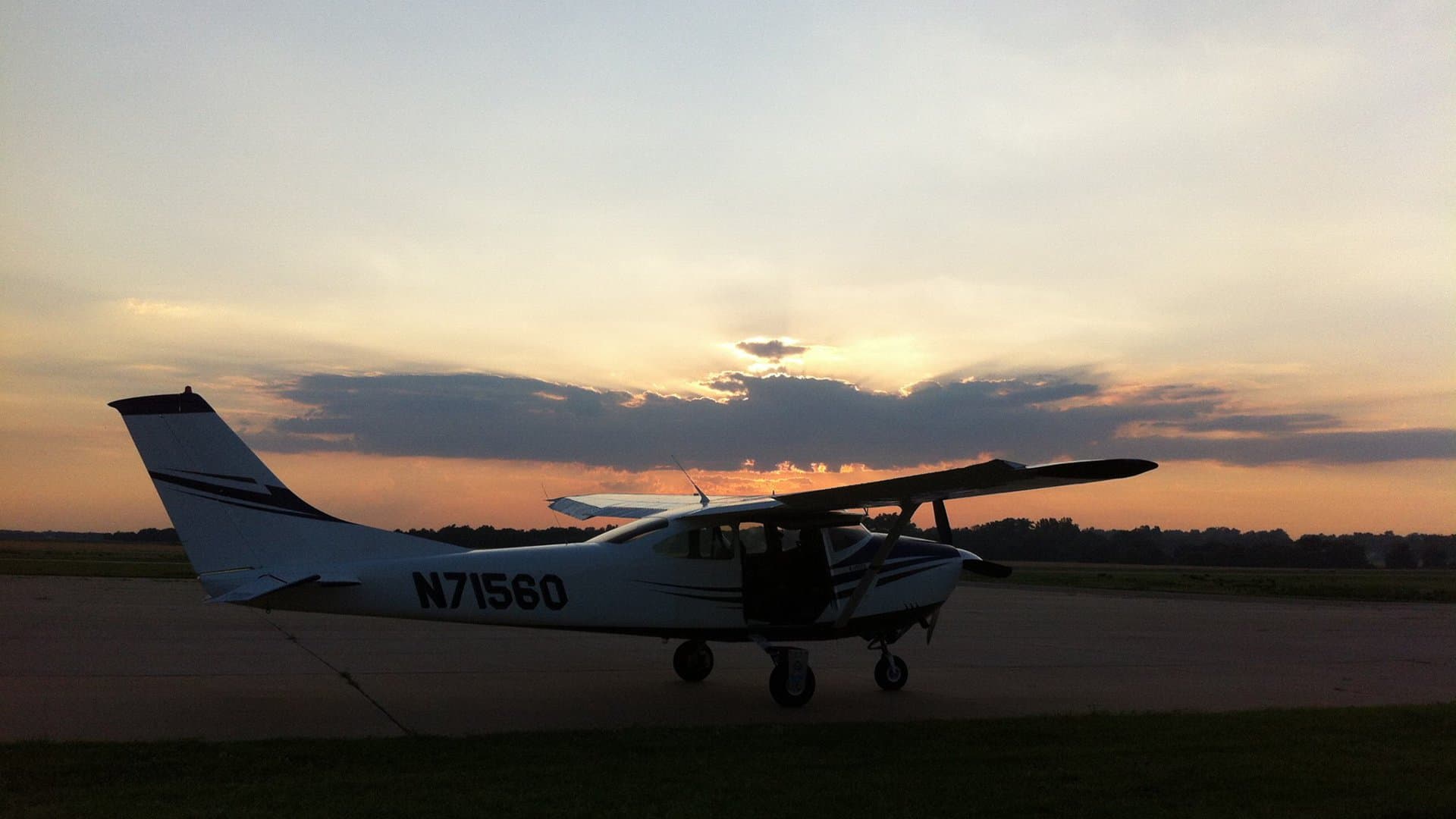 Skydive K-State's jump plane at sunset over the Kansas plains
