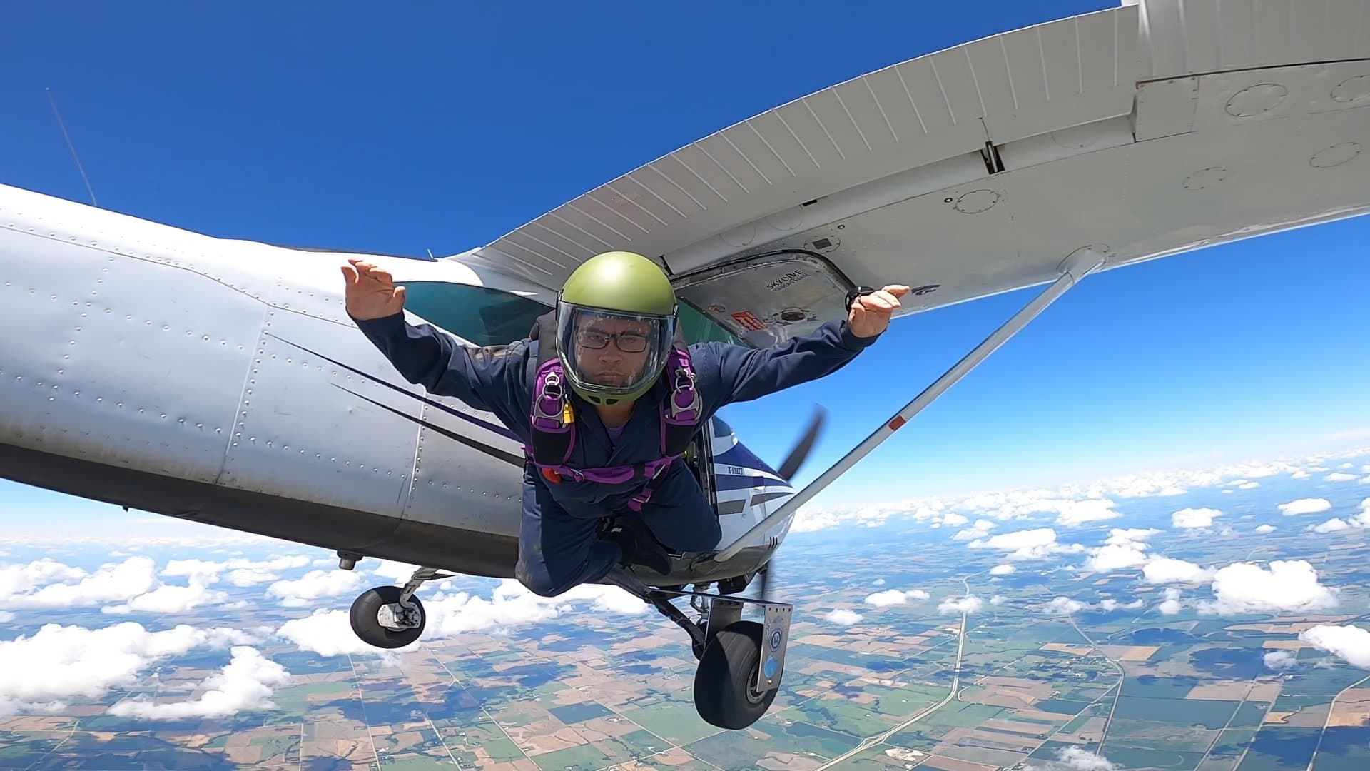A skydiver exiting the aircraft into freefall over Kansas