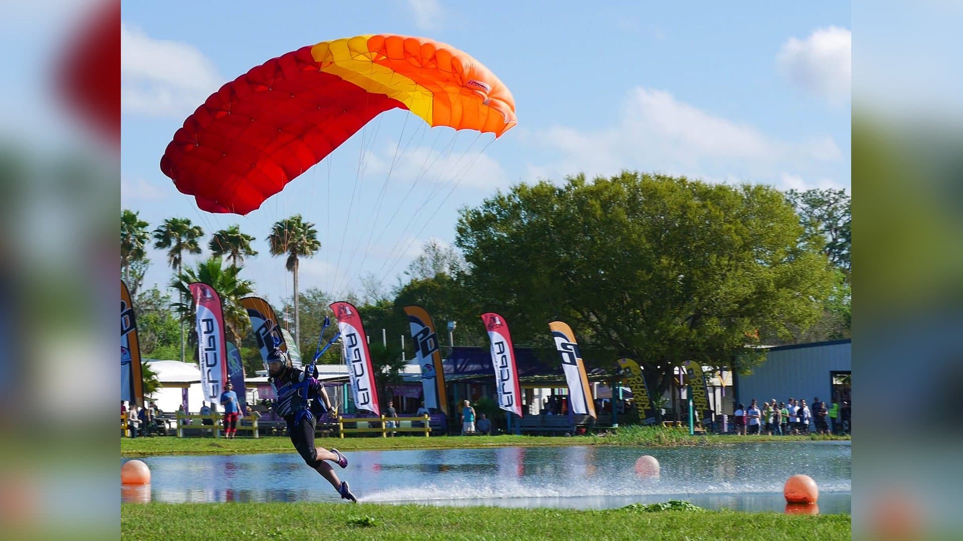 A canopy pilot swooping in to land during a competition at Skydive K-State